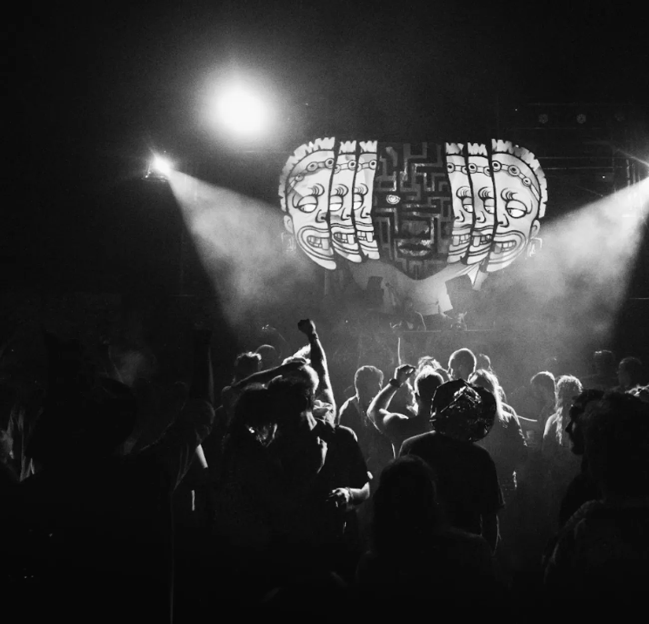 The Maw stage at night in black and white, beams cutting through the dark